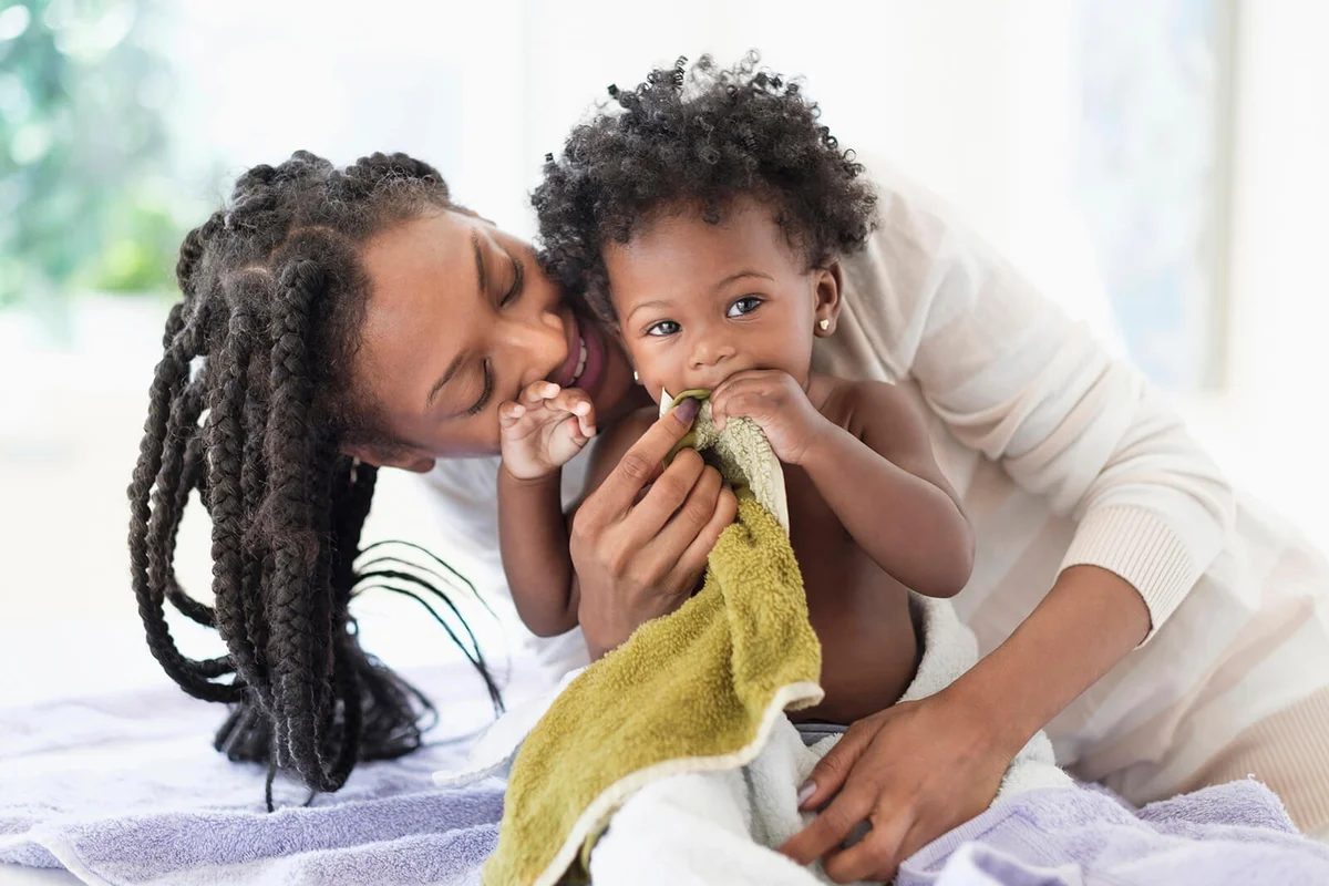 woman drying baby daughter with towels