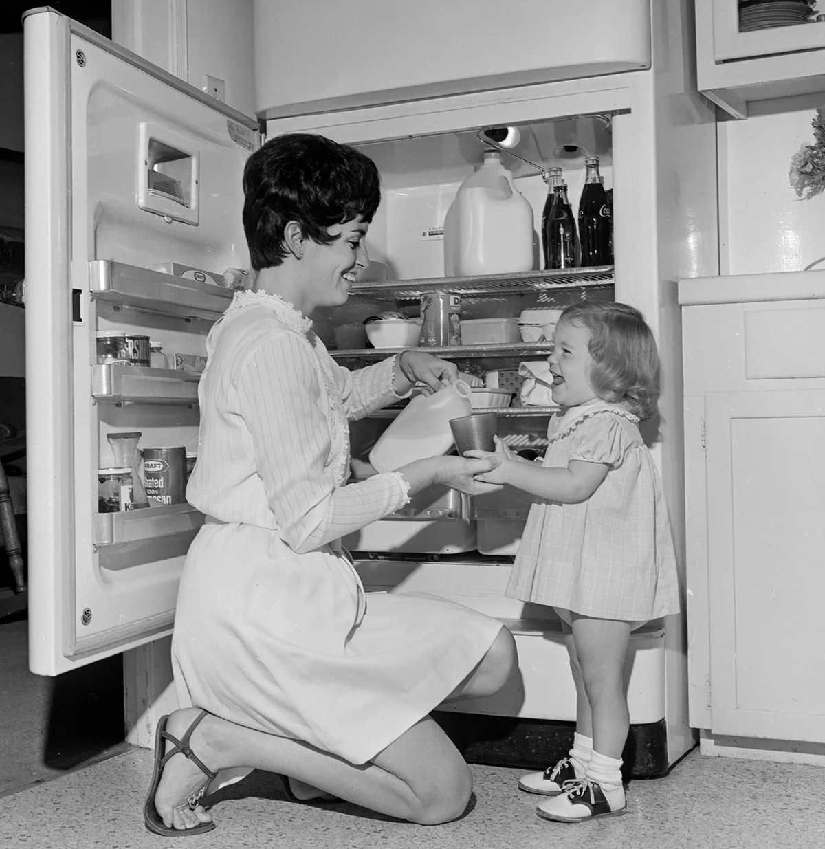 Mother and daughter at the refrigerator - Getty Editorial Use