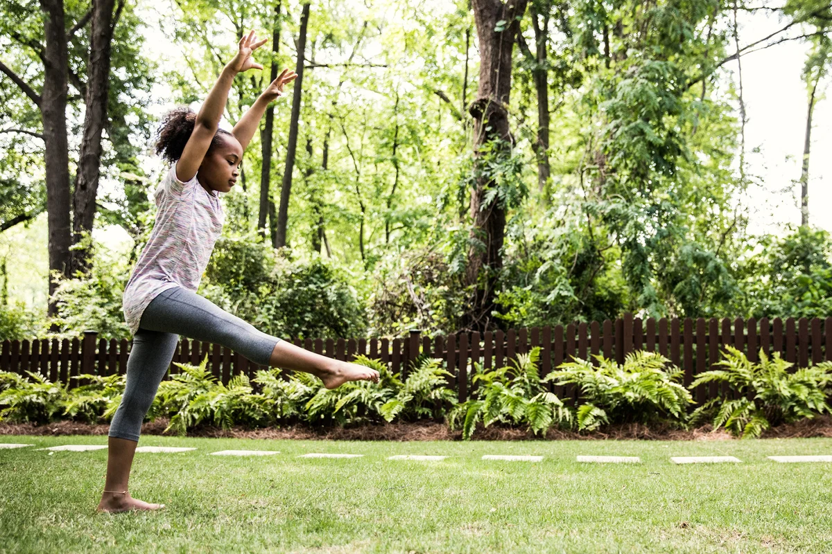 Girl doing gymnastics in backyard