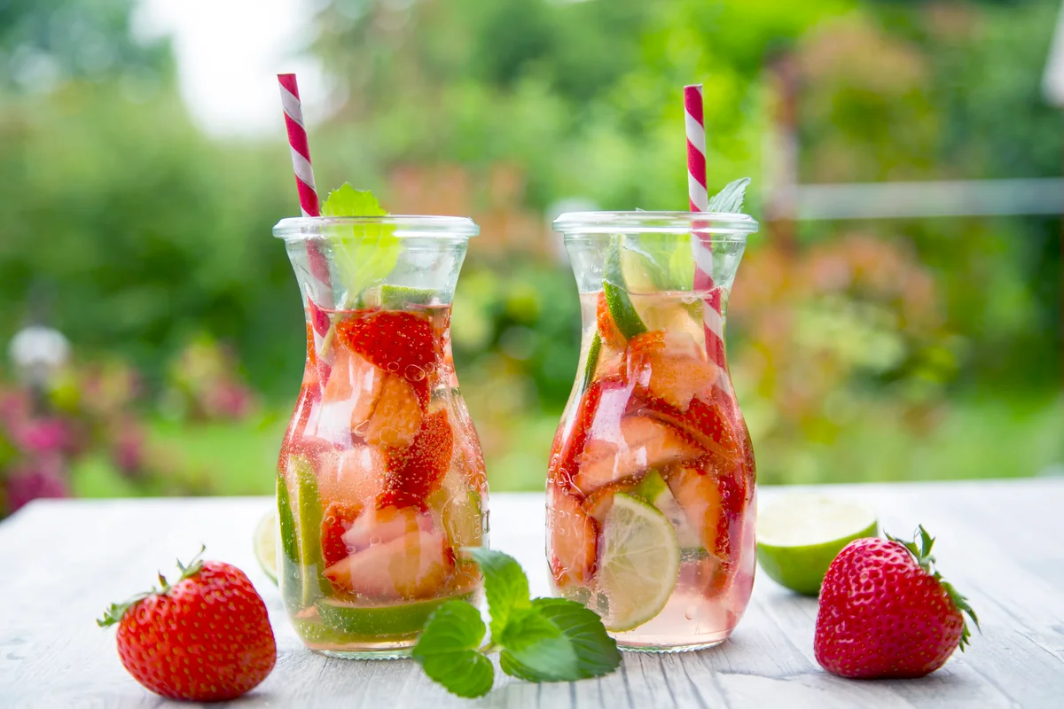 Two glass bottles of strawberry mojitos