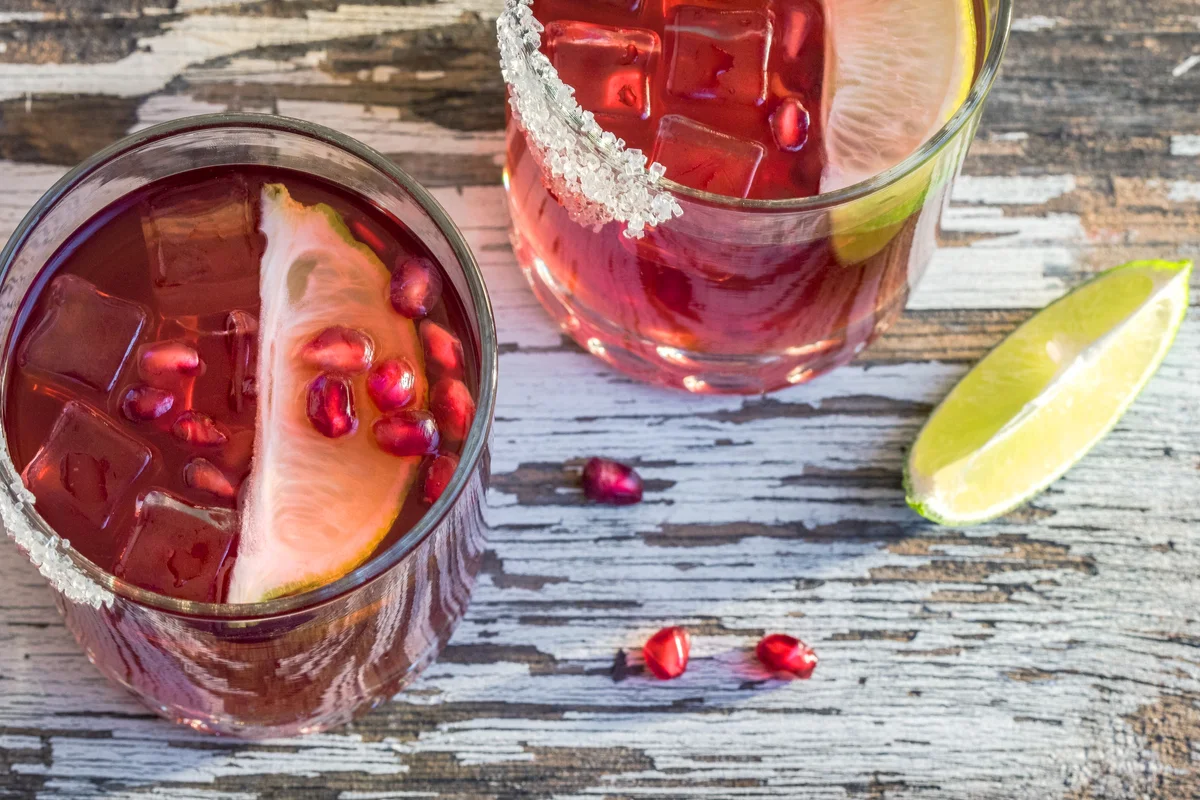 Pomegranate Lime Cocktails On Wooden Table