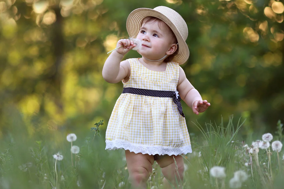 baby girl wearing sundress with hat