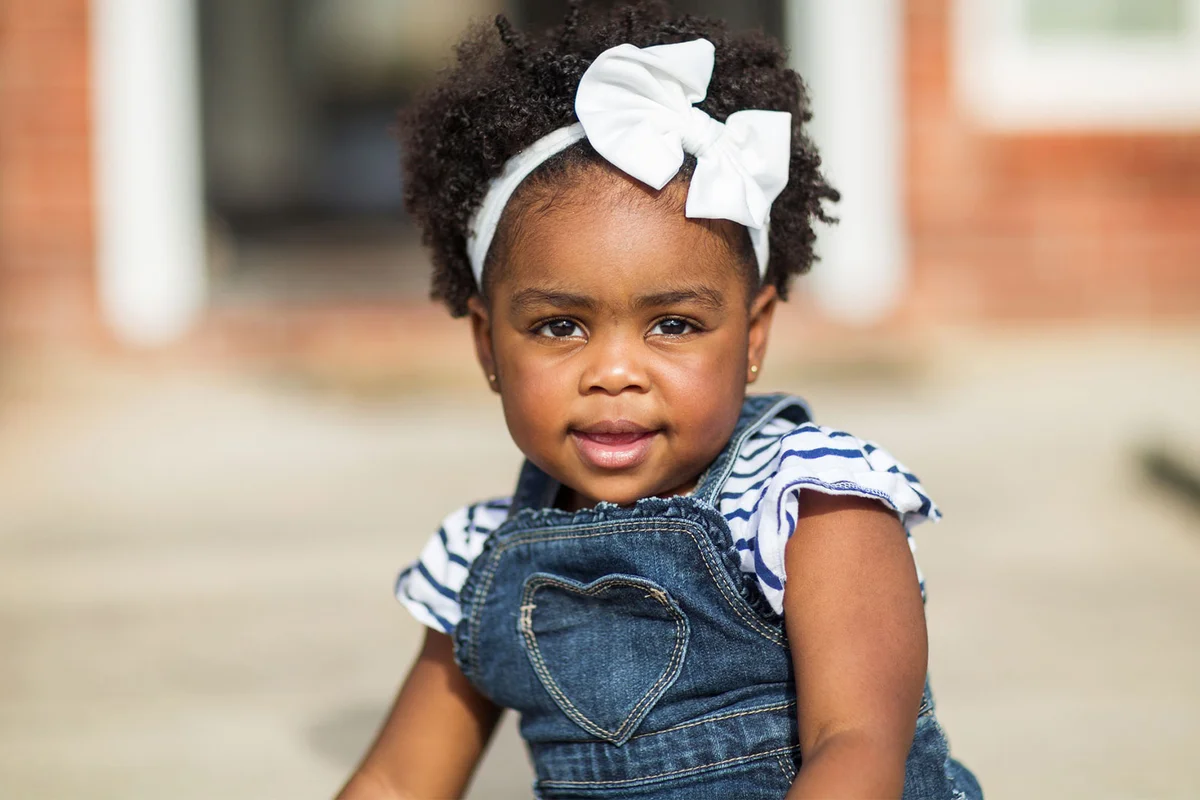 baby girl wearing denim overalls