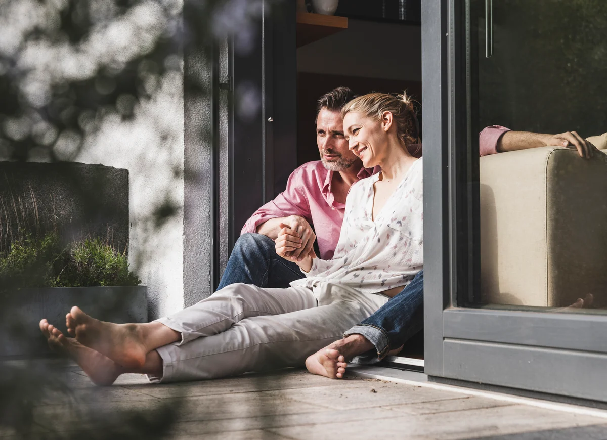 couple spending time together sitting on patio of home