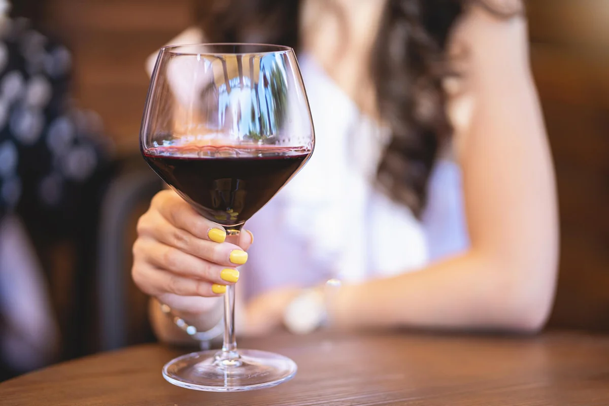 Elegant young woman holding a wineglass