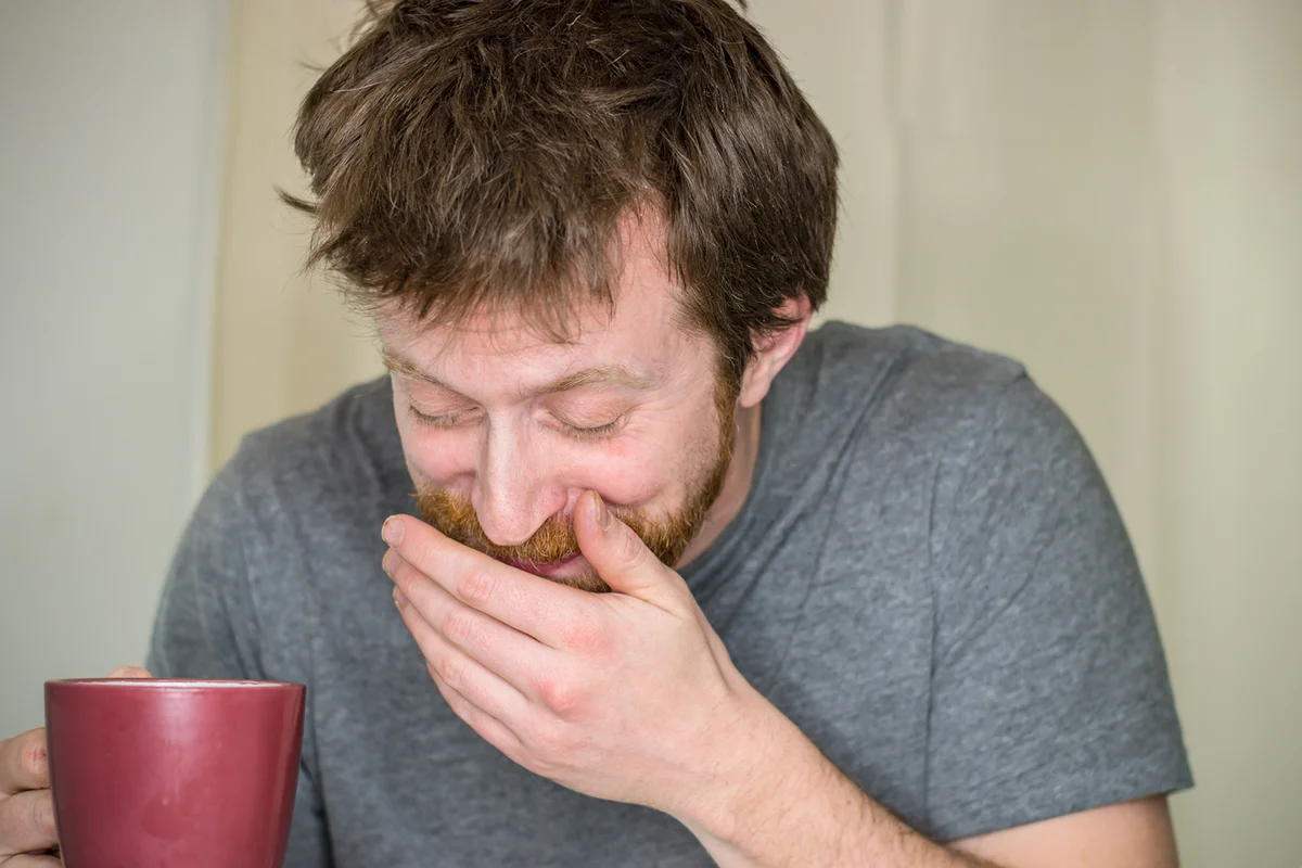 laughing so hard he spits out his coffee