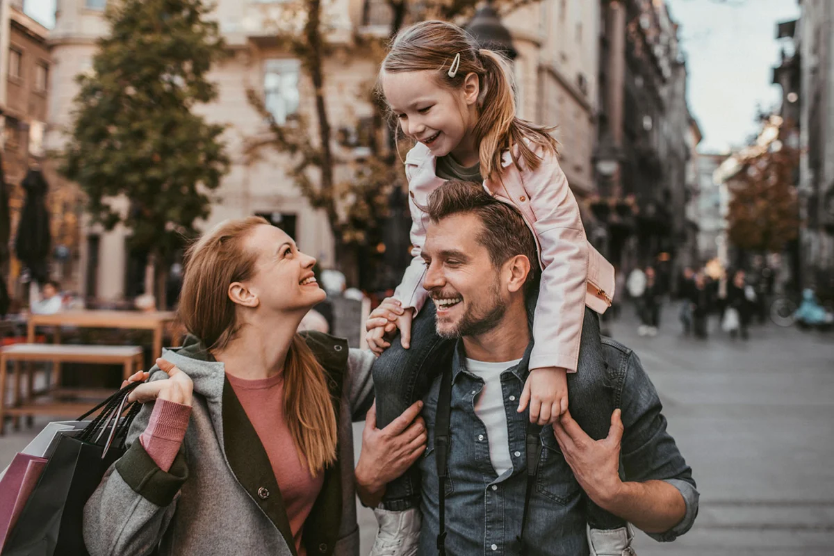 Aries man with daughter and girlfriend walking on street shopping