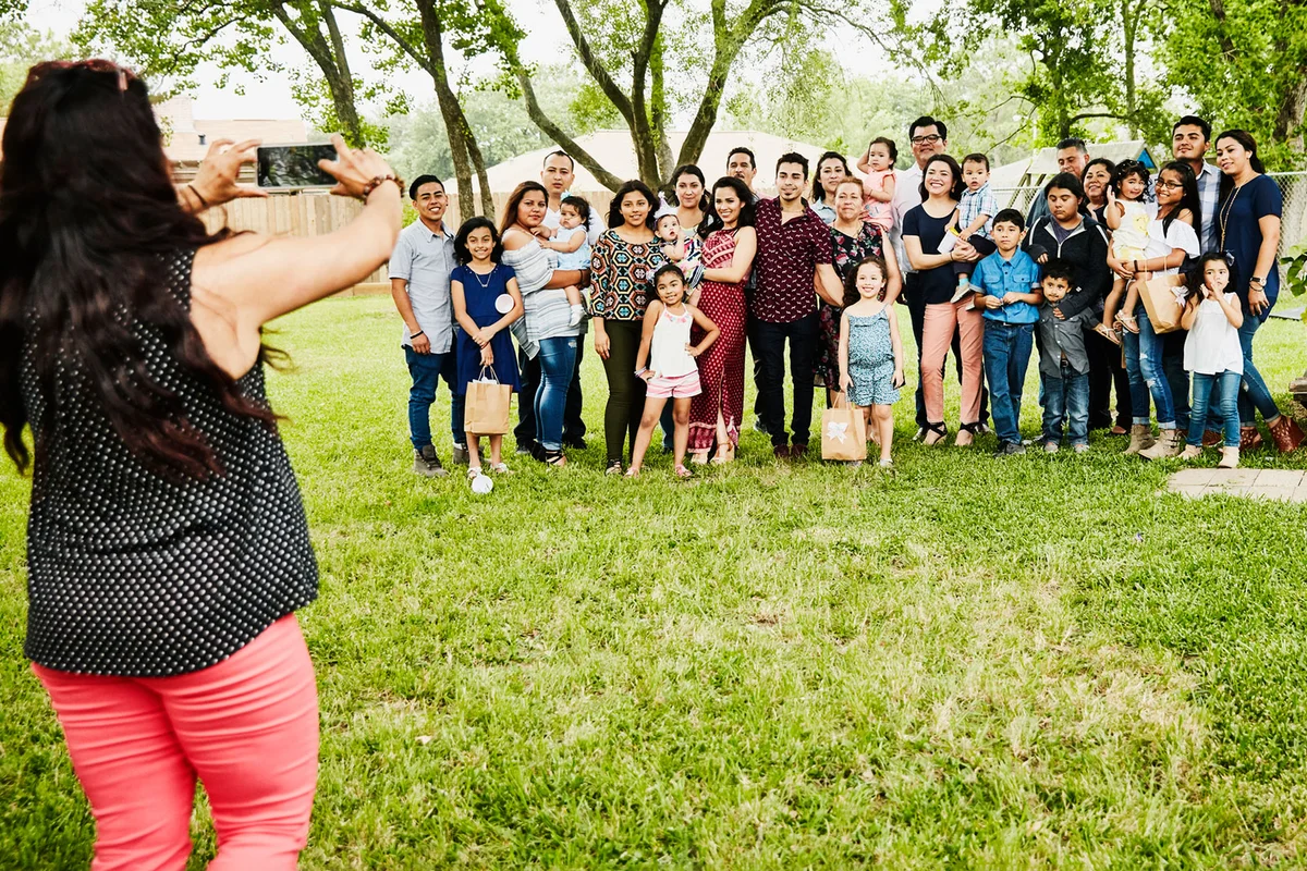 woman taking a family photo in yard