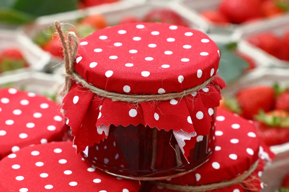 Close-Up Of Jars By Strawberries