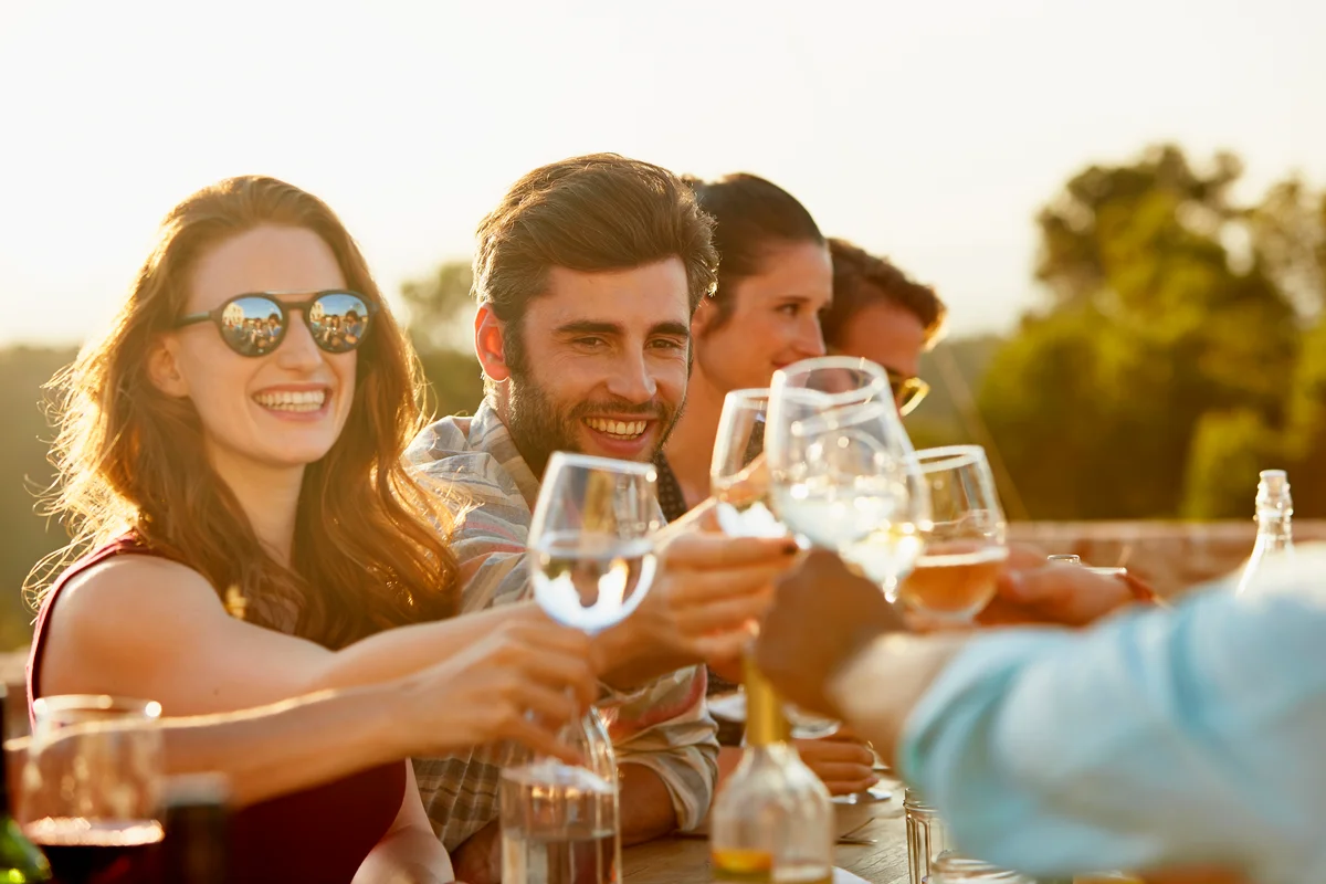 friends outside meal with wine