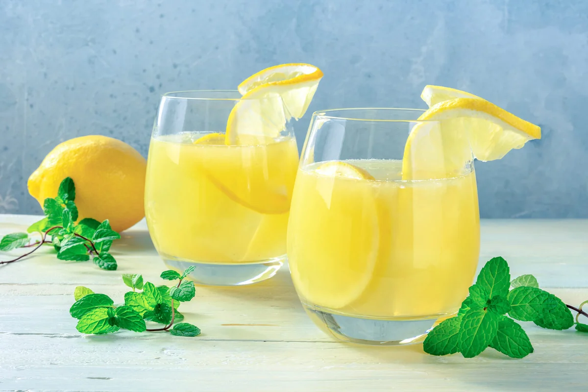 Homemade fresh citrus beverage with lemon and mint