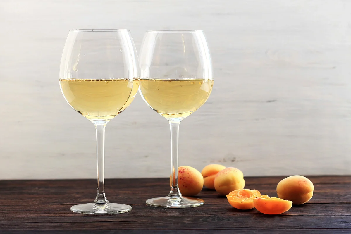 Apricots and two glasses of the white wine