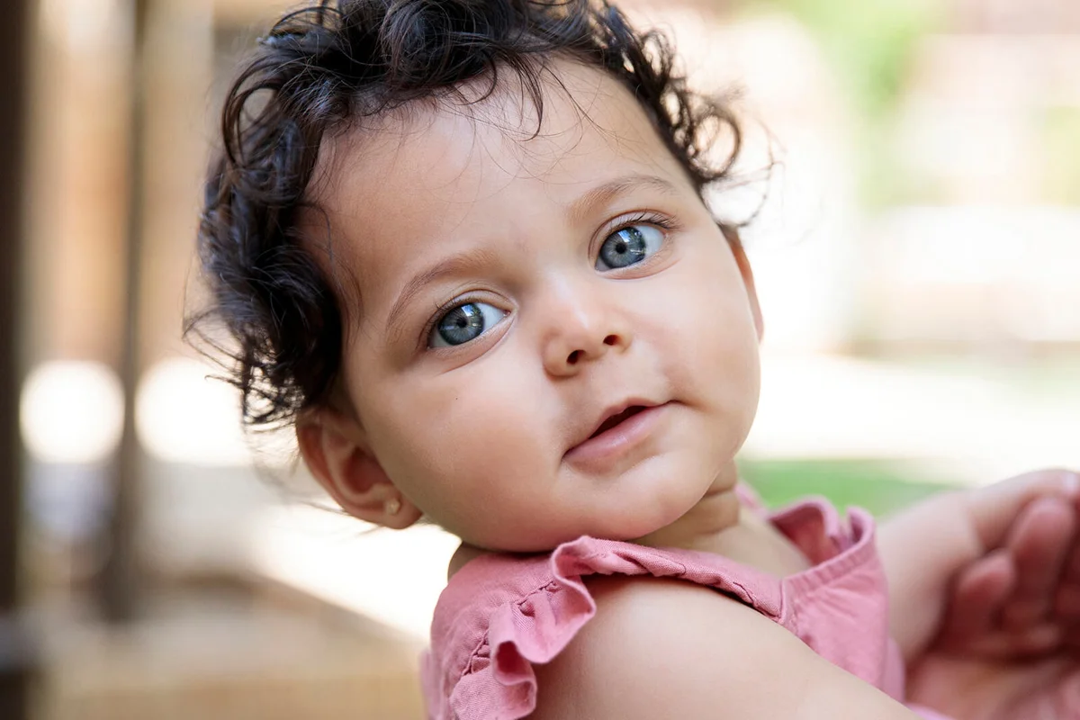 Portrait of baby with blue eyes outdoors