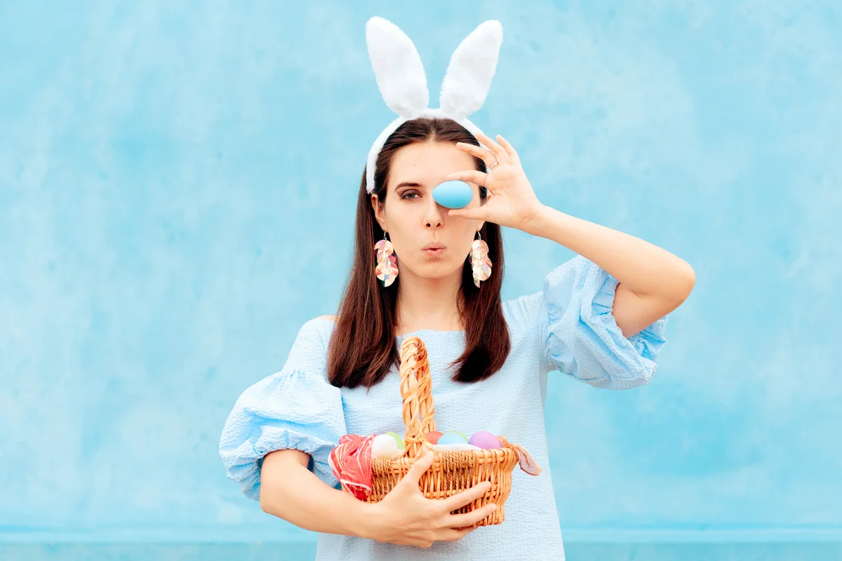 Woman Wearing Bunny Ears Holding Easter Basket of Eggs