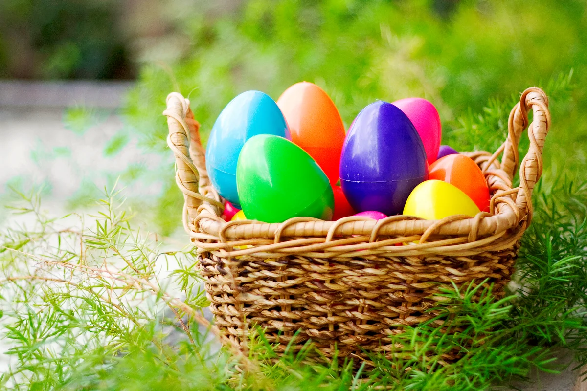 Colorful plastic Easter eggs in a wicker basket
