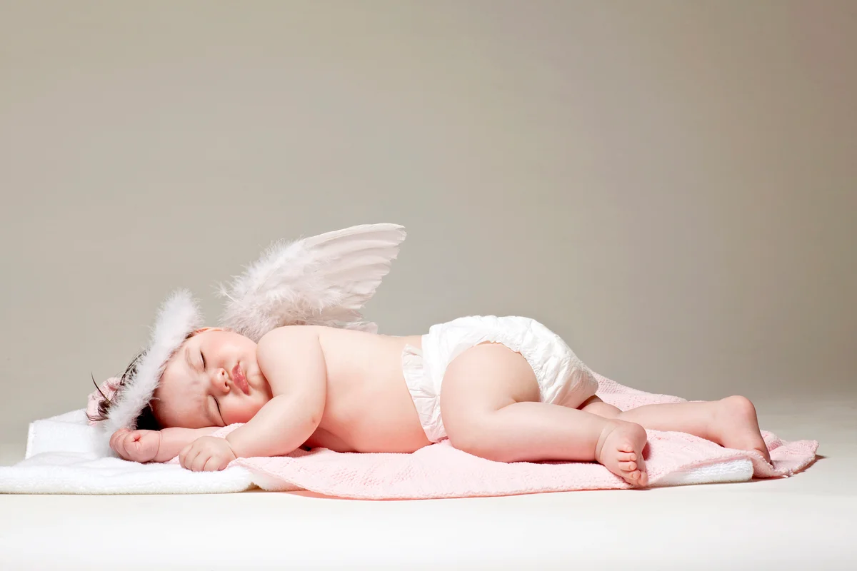 Baby girl angel sleeping on blanket