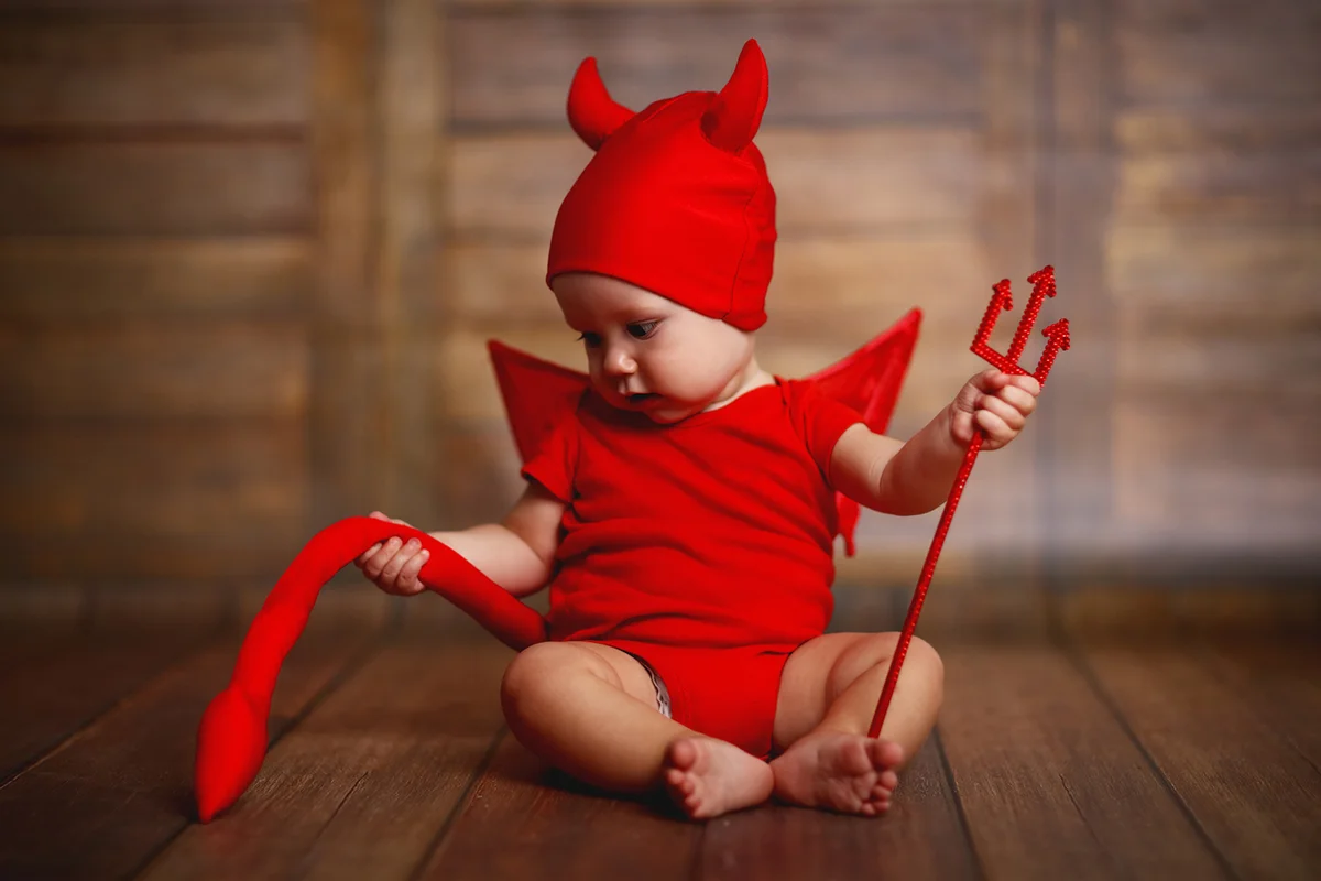 Funny baby in devil costume
