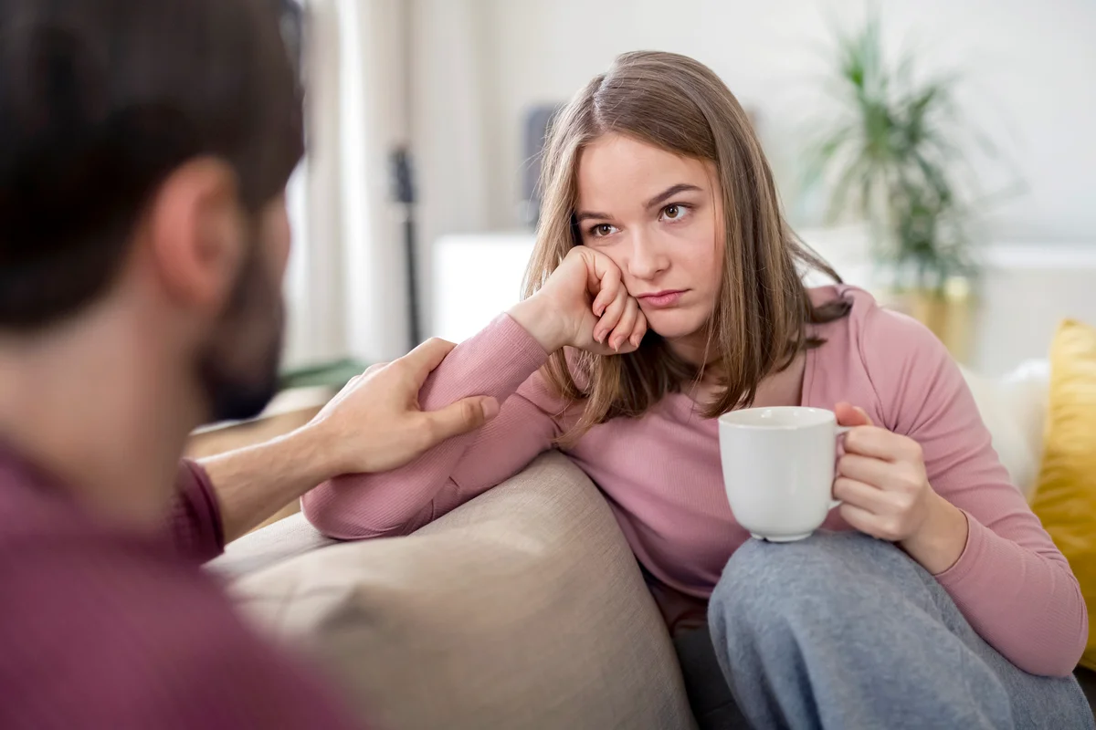 Upset couple having a conversation in the sofa