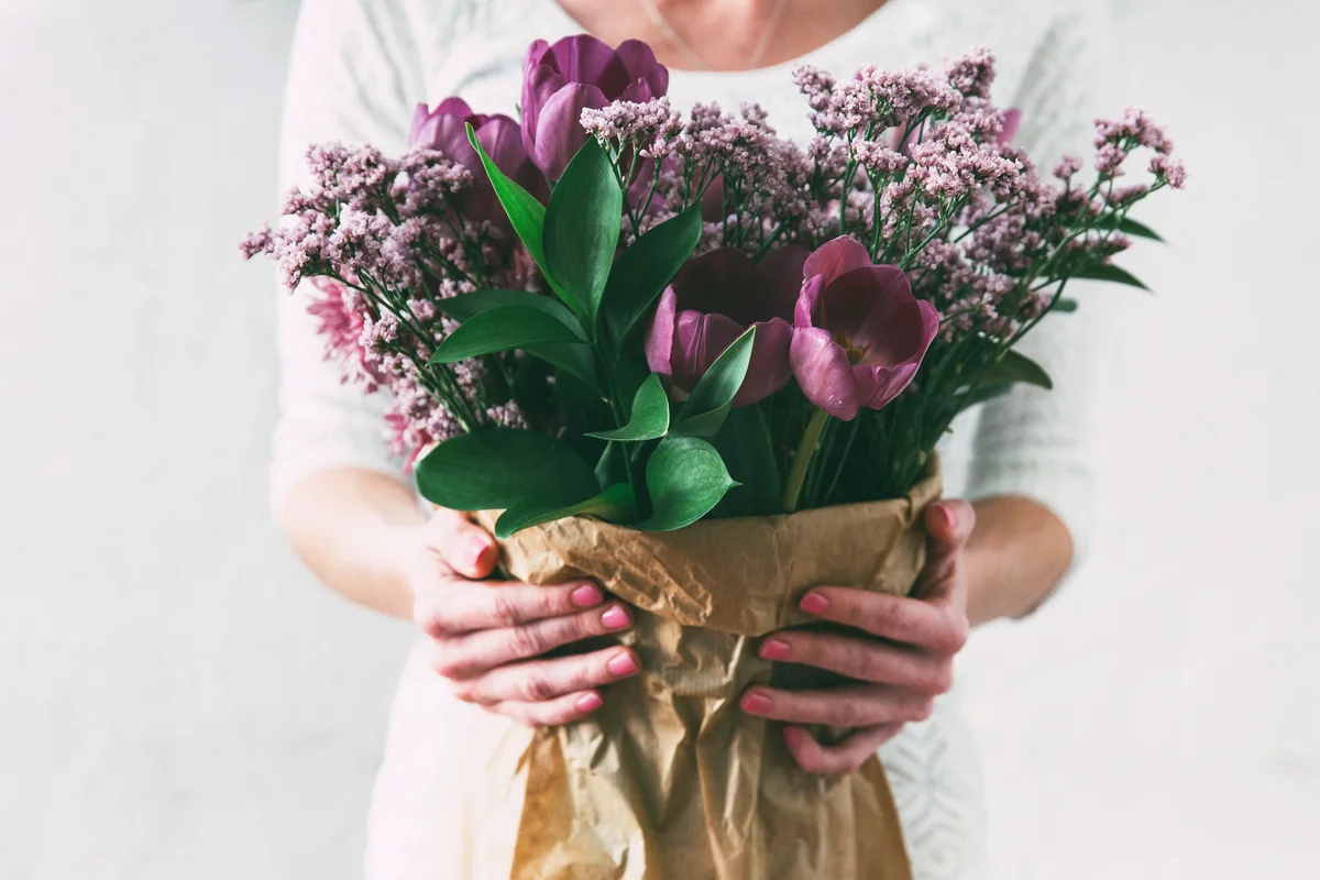 Bouquet of spring tulips flowers wrapped in gift paper