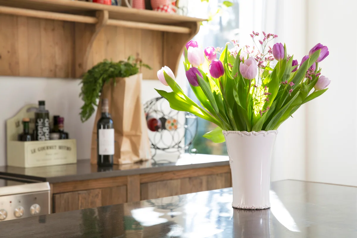 Bunch of tulips in a vase on kitchen counter