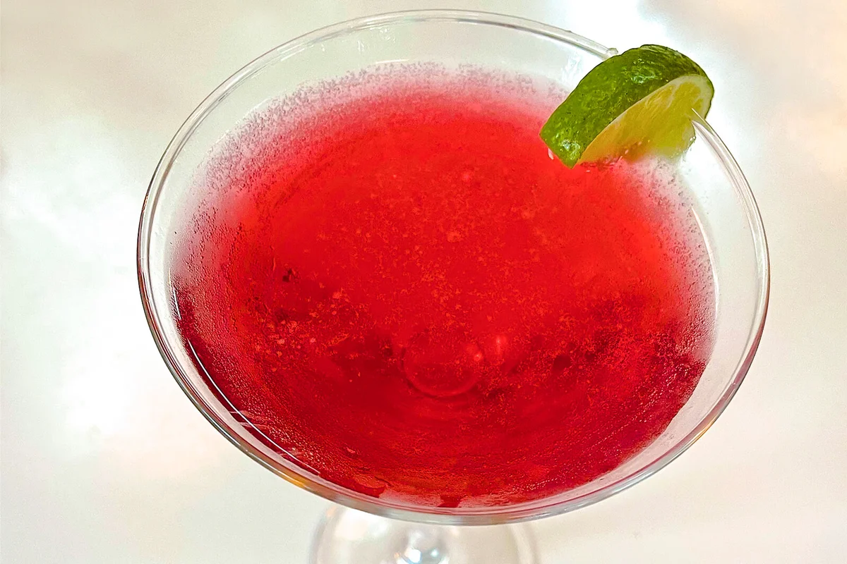 Close-up of Cape Codder drink with lime served in martini glass