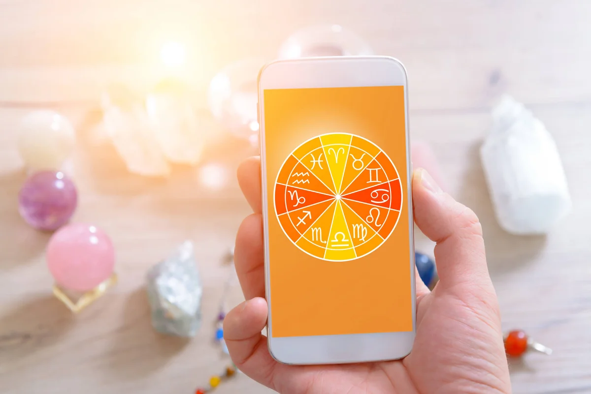 Zodiac signs and smart phone in hand