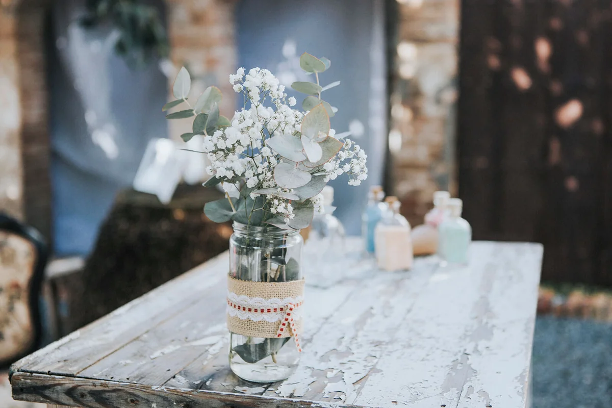 Paniculata bouquet in glass jar on old table