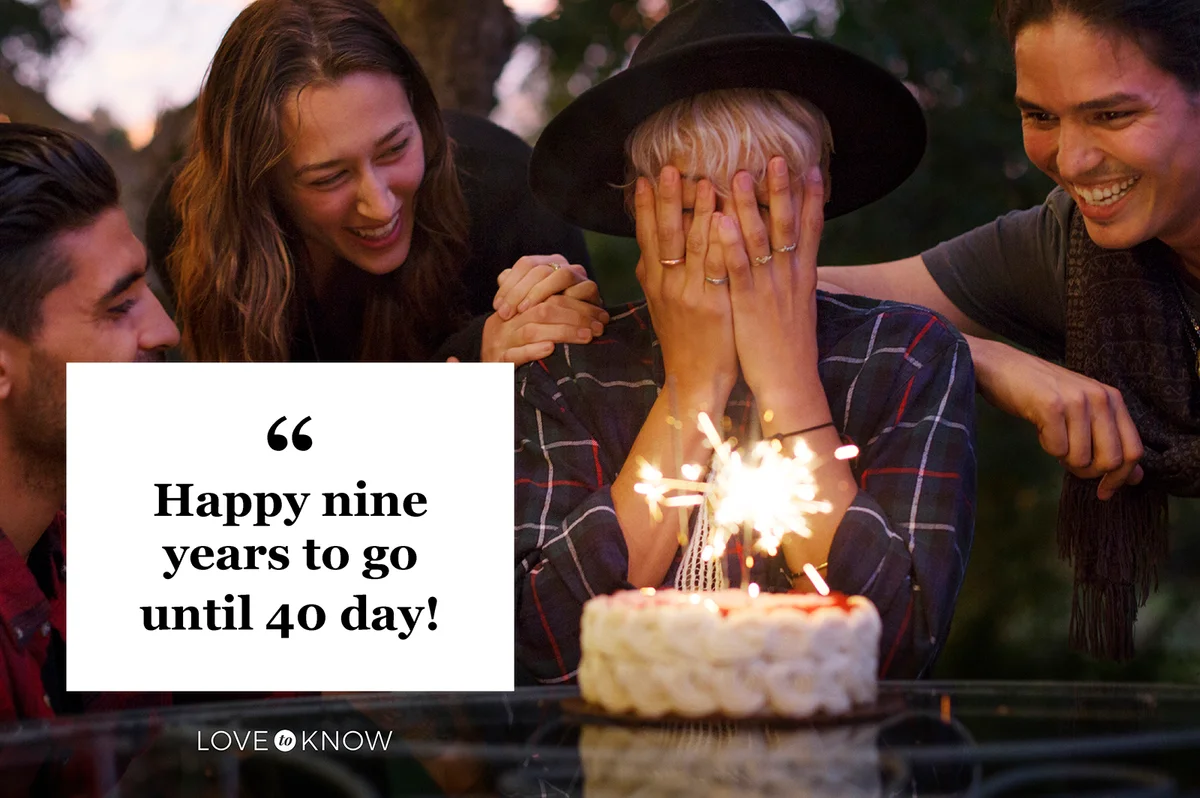 Woman covering her face while friends looking at birthday cake