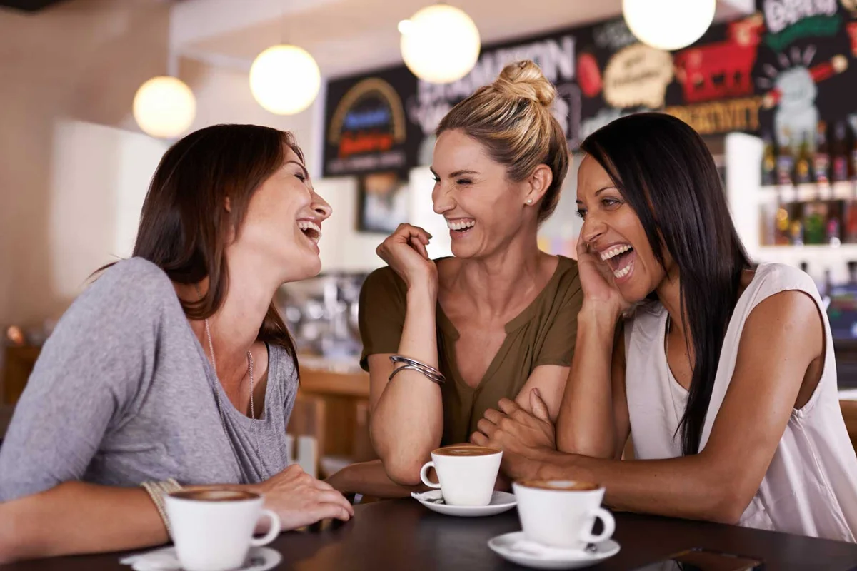 three women having coffee at restaurant together