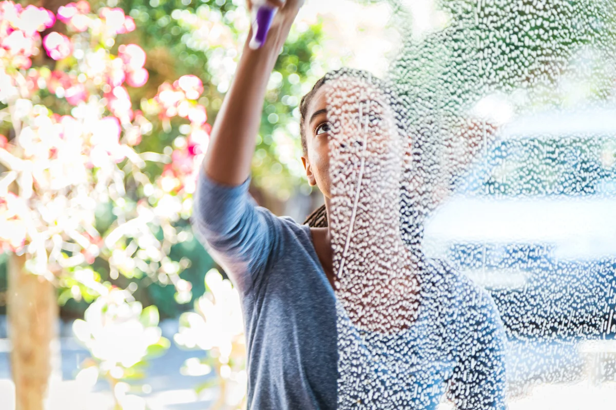 Woman washing window