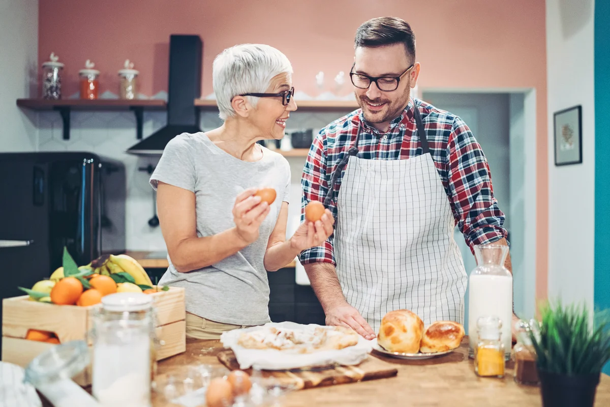 Mother and son preparing sweet pie together