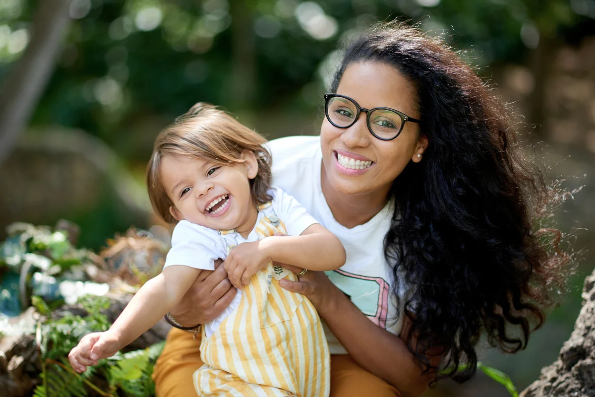 Shot of an adorable little girl having fun with her godmother in the park