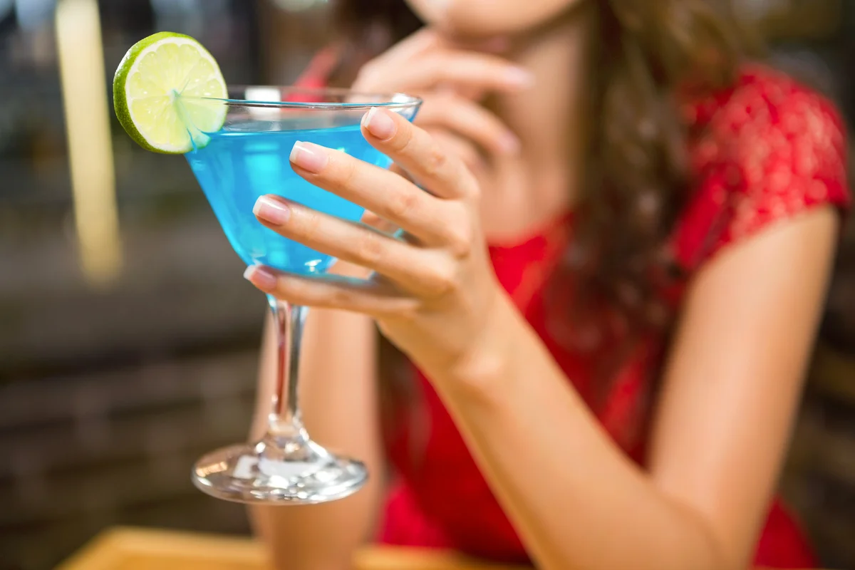 Woman having a blue margarita