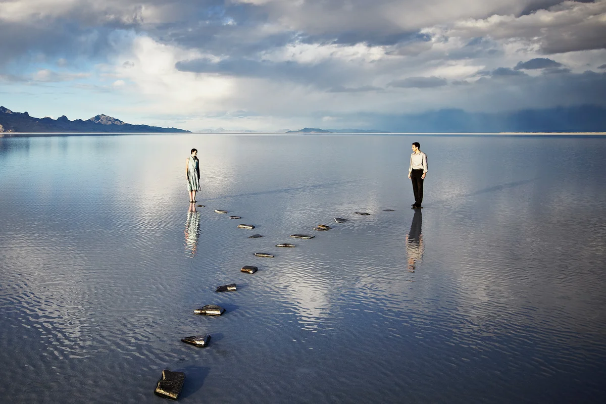 Couple on separate pathways in water