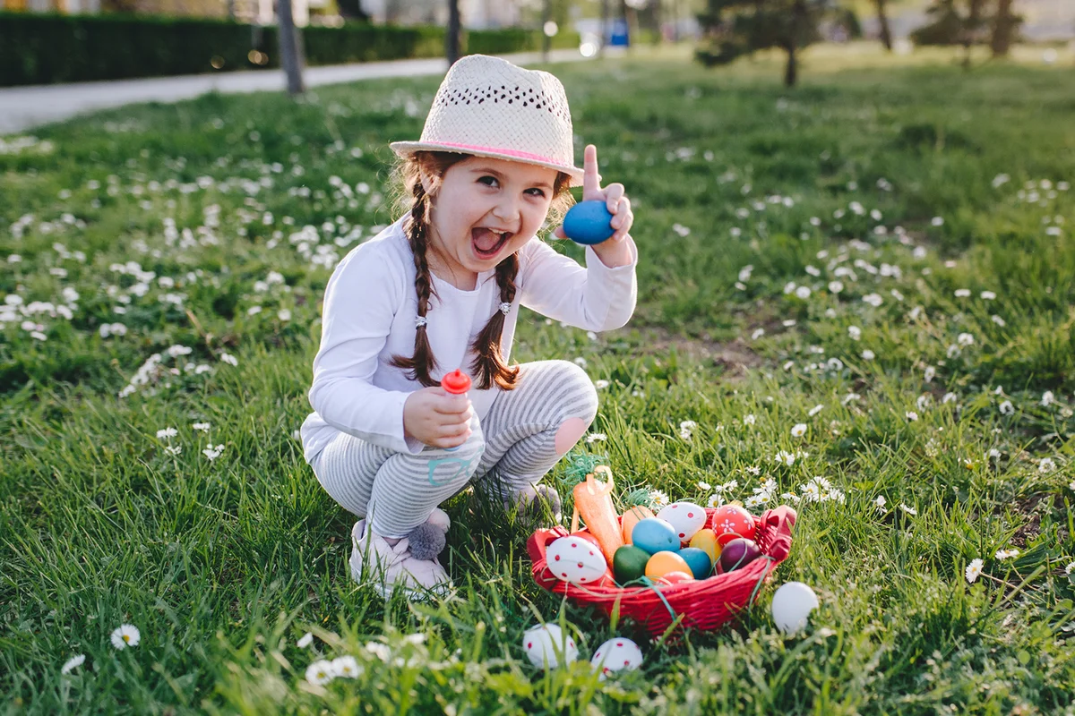 Girl holding an egg she found during an easter egg hunt