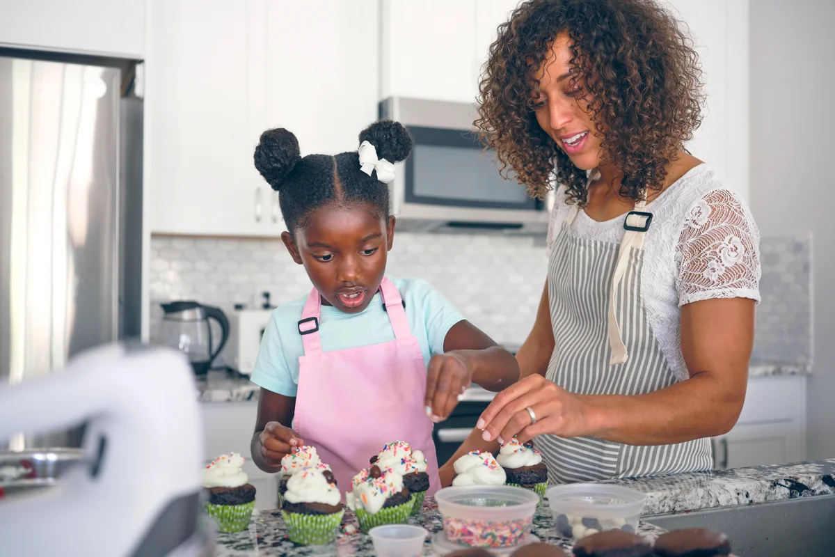 Mother and Daughter Baking Cupcakes in a Home Kitchen