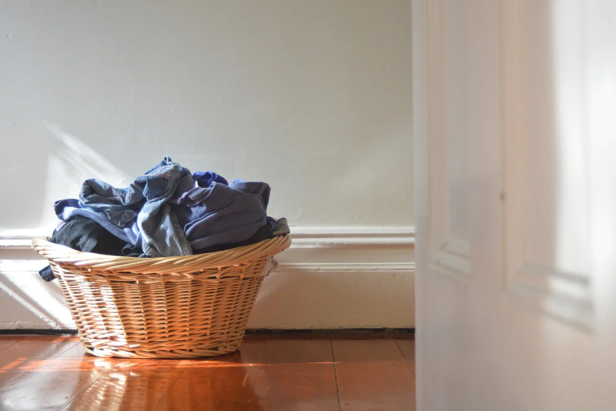 Clothes In Basket Against Wall At Home