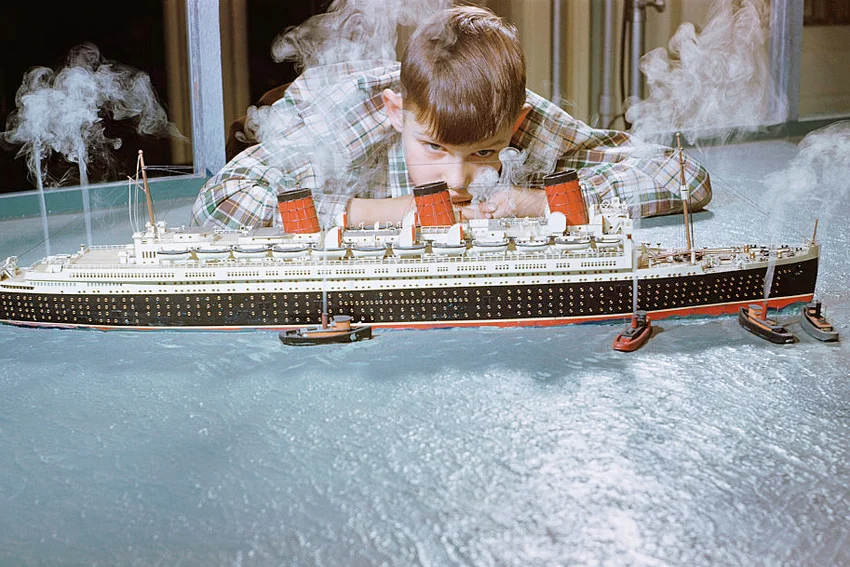Boy Playing with Toy Ocean Liner