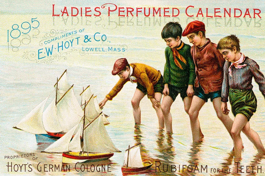 Boys wading at the edge of a lake, playing with their toy sailboats