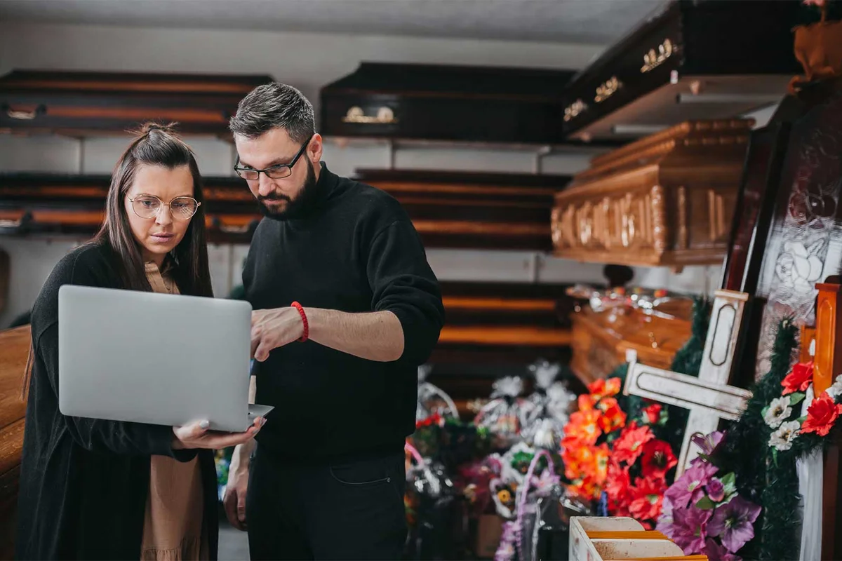 two people planning a funeral with a checklist