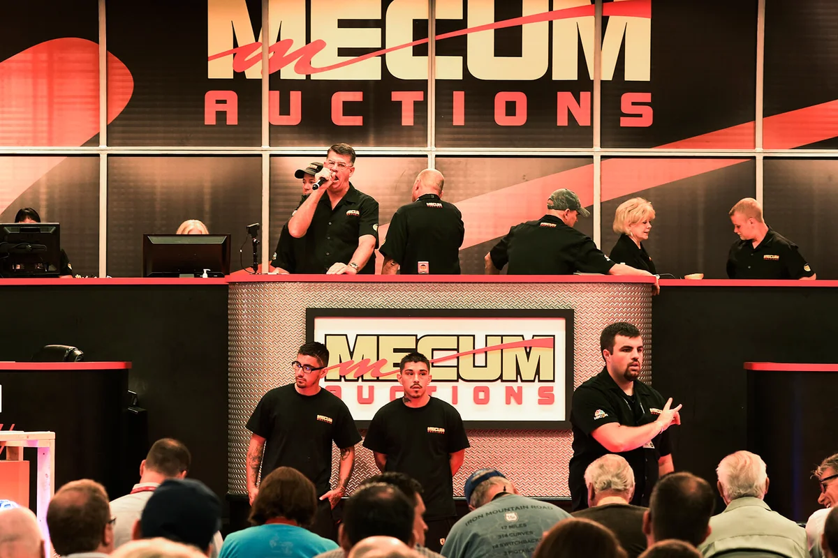 Auctioneers take in bids during the Mecum Auctions, the big player in collectible cars, at the Colorado Convention Center, June 26, 2015 | Getty Editorial Use