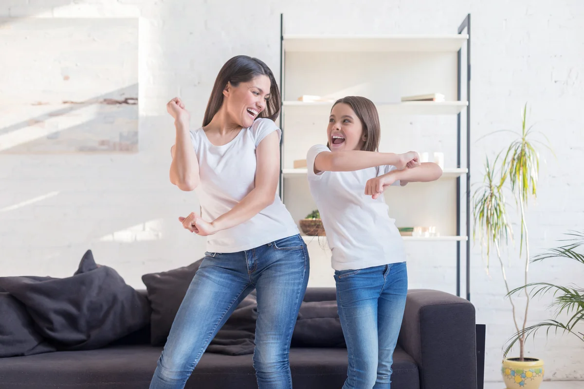 Mom with daughter dancing in living room