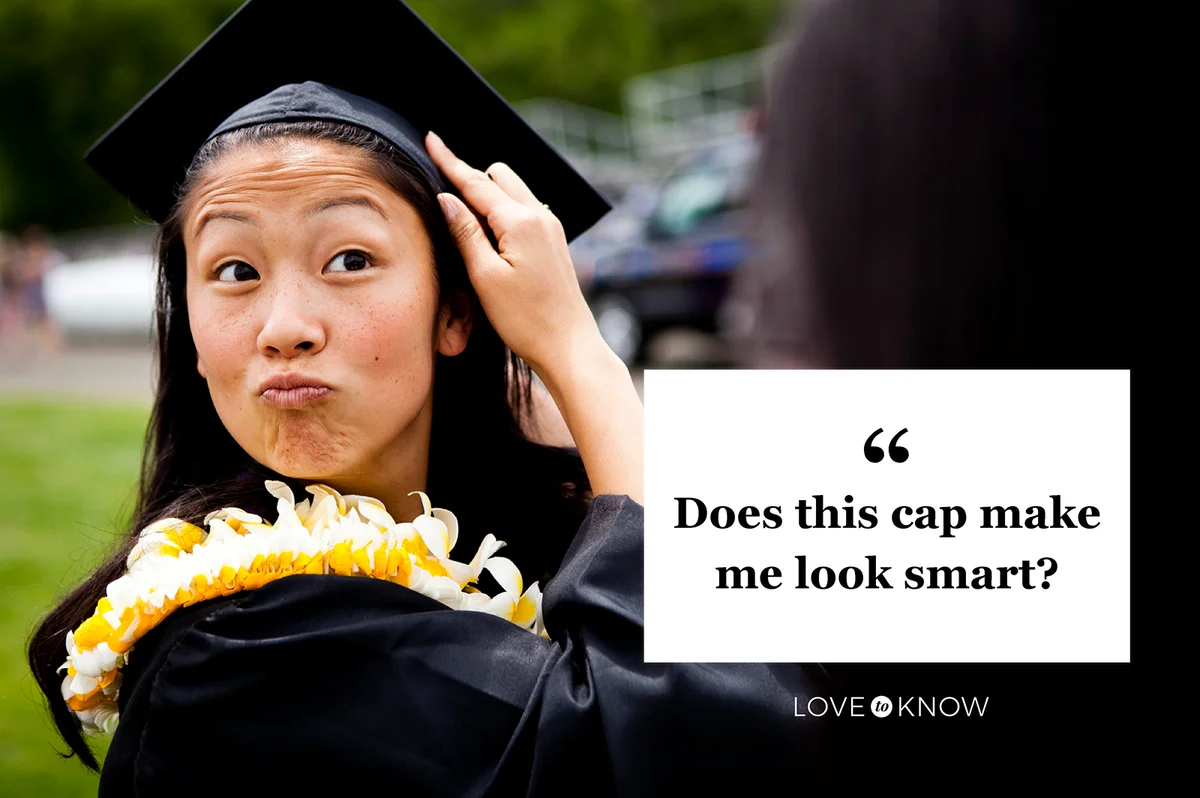 Graduate makes funny faces while touching her cap