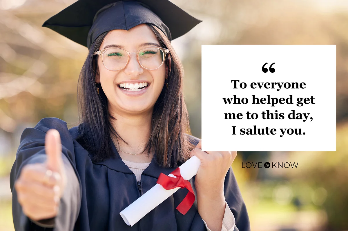 Young woman showing thumbs up on graduation day