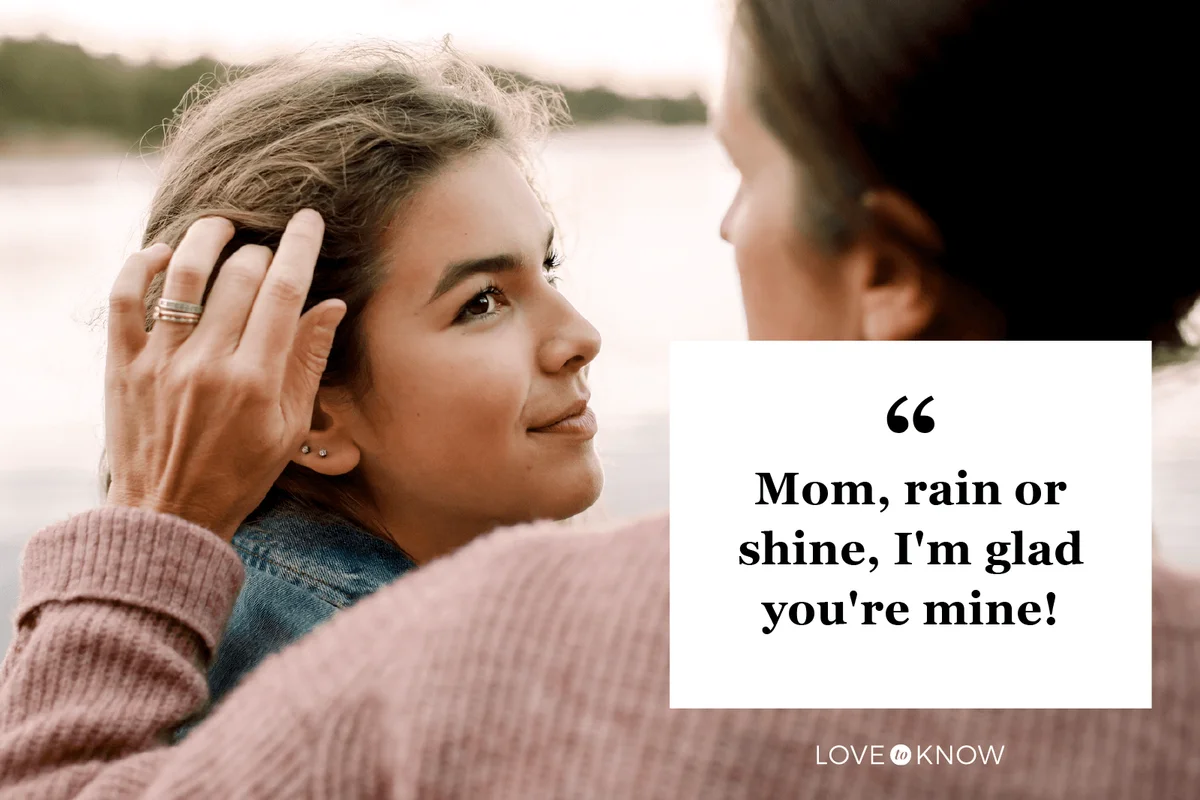 Smiling daughter looking at caring mother by lake