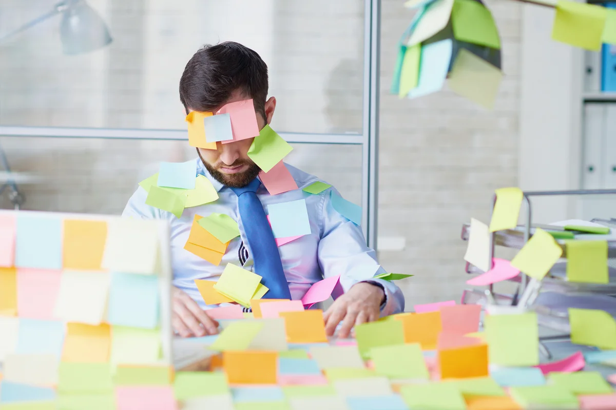 Pranked office worker with sticky notes