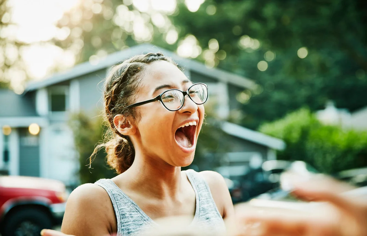 Laughing young woman hanging out with neighborhood friends