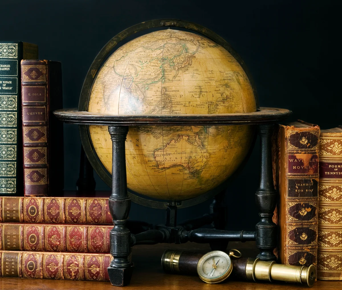Old fashioned globe and books on table