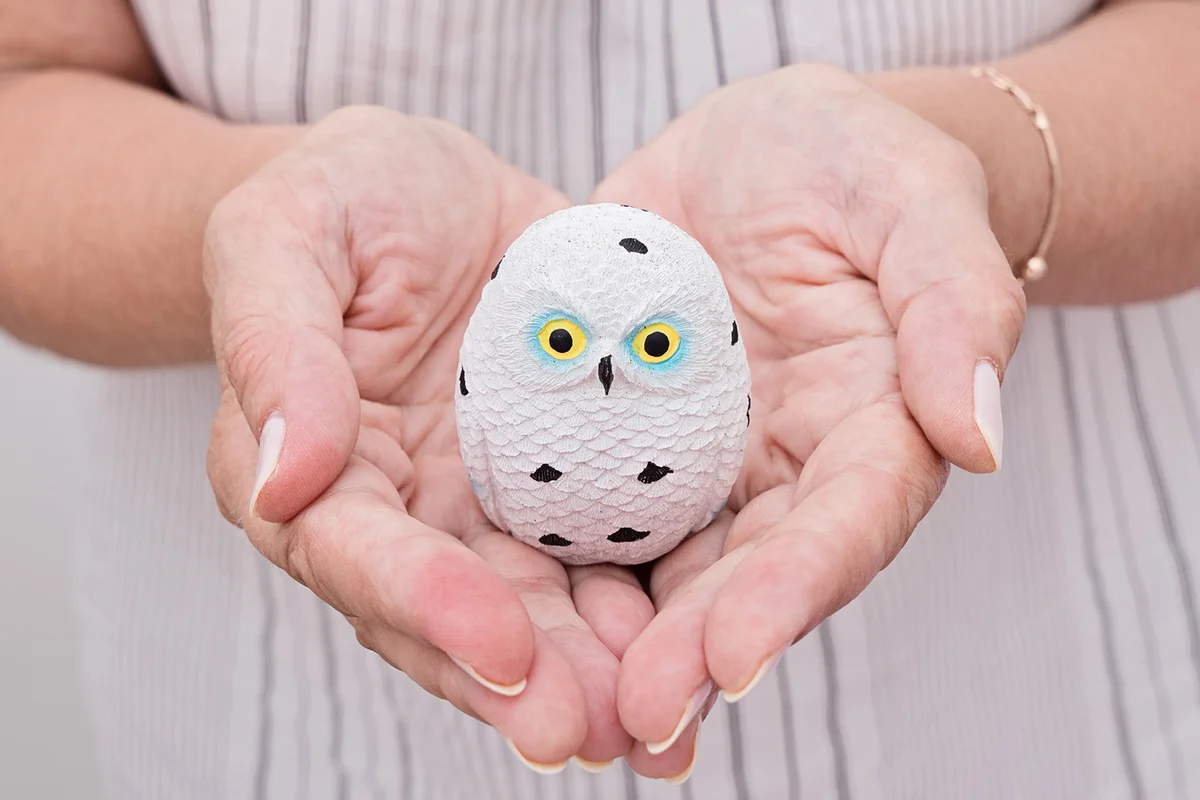 Woman Holding Owl Figurine