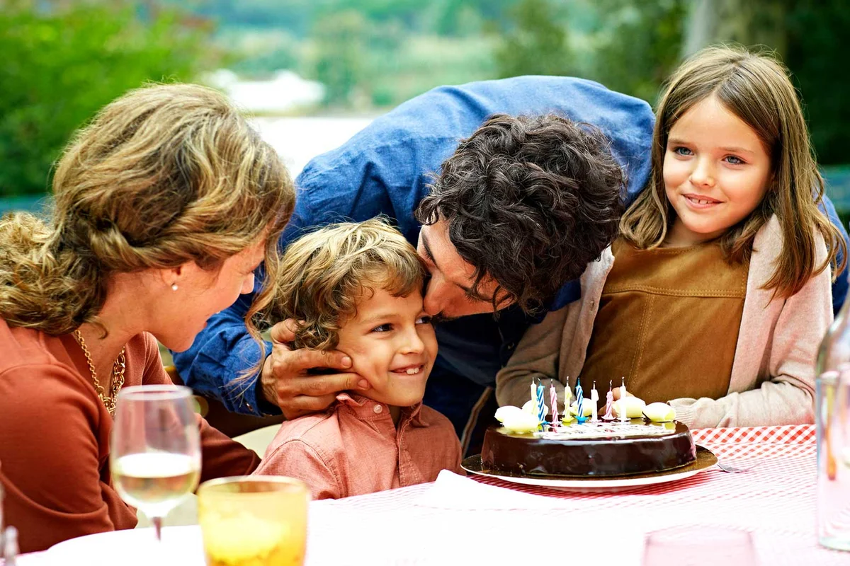 family celebrating sons birthday